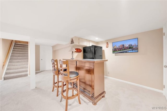 6157 Walnut Creek Ct, Clarence, NY 14051 - indoor dry bar with freestanding refrigerator, light colored carpet, baseboards, and stairs