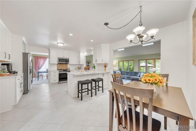 6157 Walnut Creek Ct, Clarence, NY 14051 - dining room featuring a chandelier, plenty of natural light, light tile patterned floors, and recessed lighting