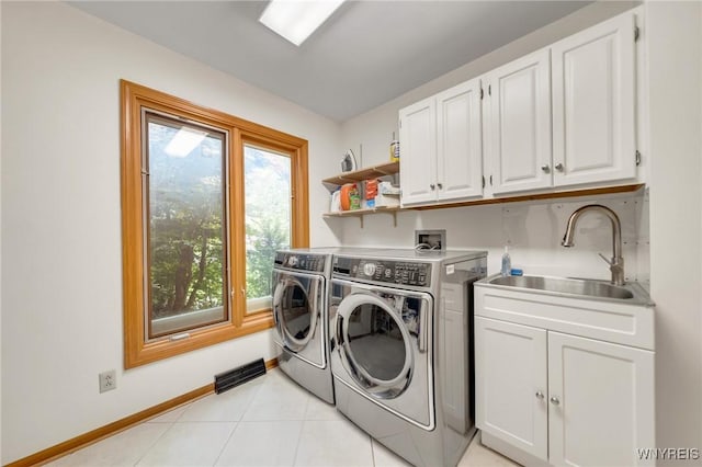 6157 Walnut Creek Ct, Clarence, NY 14051 - laundry room with washer and clothes dryer, cabinet space, light tile patterned flooring, and baseboards