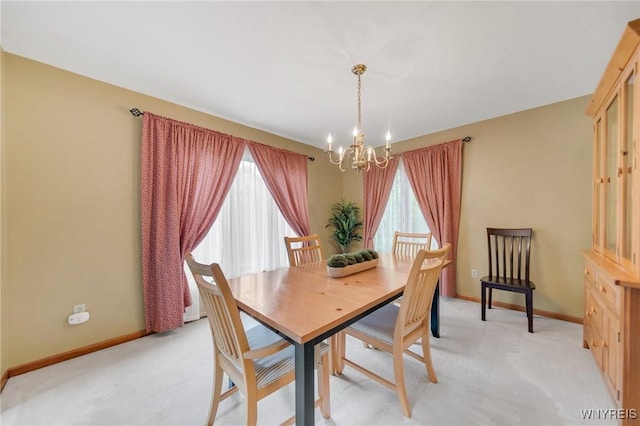 6157 Walnut Creek Ct, Clarence, NY 14051 - dining room featuring a chandelier, light carpet, and baseboards