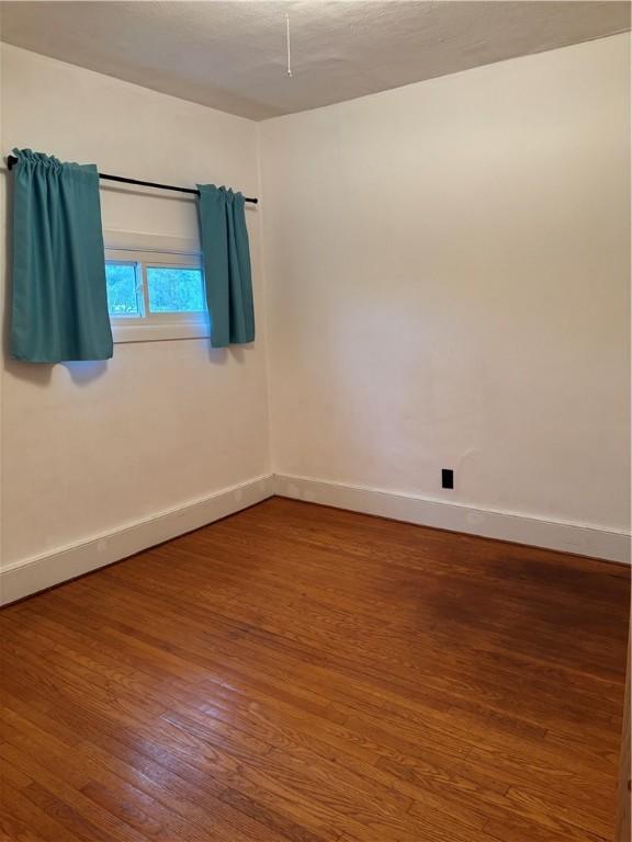 6940 County Highway 18, Plainfield, NY 13491 - unfurnished room featuring wood finished floors and baseboards