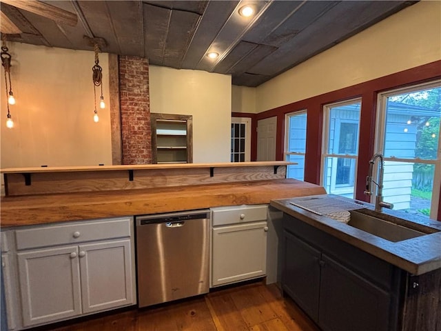 6940 County Highway 18, Plainfield, NY 13491 - kitchen with stainless steel dishwasher, wooden counters, a sink, dark wood-type flooring, and a peninsula