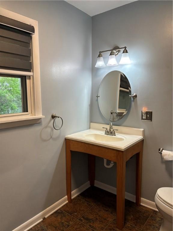 6940 County Highway 18, Plainfield, NY 13491 - half bath with toilet, baseboards, and vanity