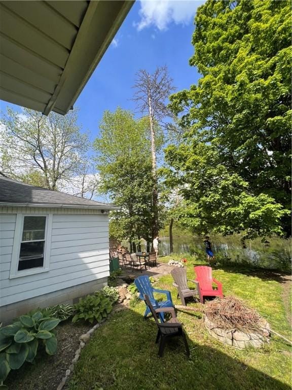 6940 County Highway 18, Plainfield, NY 13491 - view of green lawn featuring a patio and a fire pit