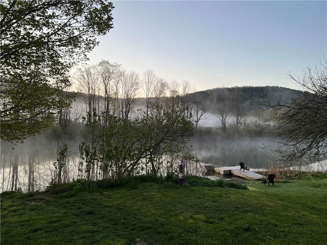 6940 County Highway 18, Plainfield, NY 13491 - water view featuring a boat dock and a mountain backdrop