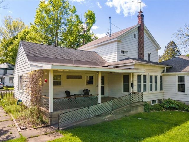 6940 County Highway 18, Plainfield, NY 13491 - view of front of property with a front yard, roof with shingles, a chimney, and a porch