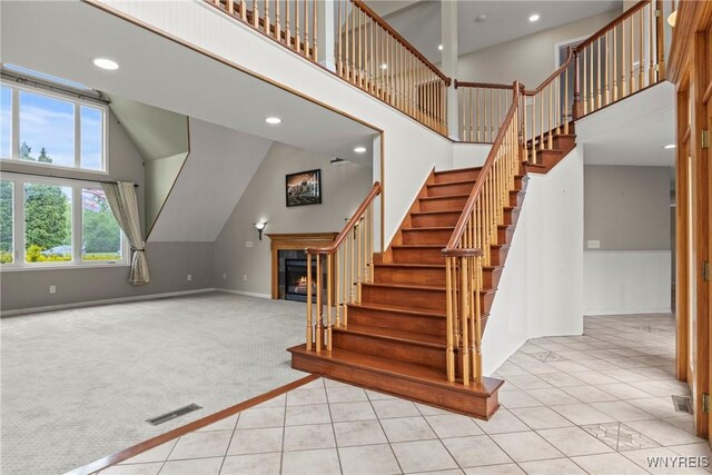 60 Gaylord Ct, Elma, NY 14059 - staircase with carpet, high vaulted ceiling, tile patterned floors, recessed lighting, and baseboards