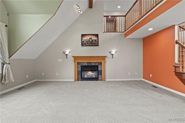 60 Gaylord Ct, Elma, NY 14059 - unfurnished living room with stairs, carpet flooring, baseboards, a fireplace, and high vaulted ceiling