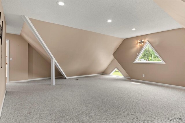 60 Gaylord Ct, Elma, NY 14059 - bonus room with carpet flooring, vaulted ceiling, recessed lighting, a textured ceiling, and baseboards