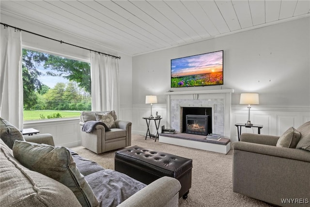 1822 Grover Rd, Aurora, NY 14052 - carpeted living area with wooden ceiling, a decorative wall, a wainscoted wall, and a tiled fireplace