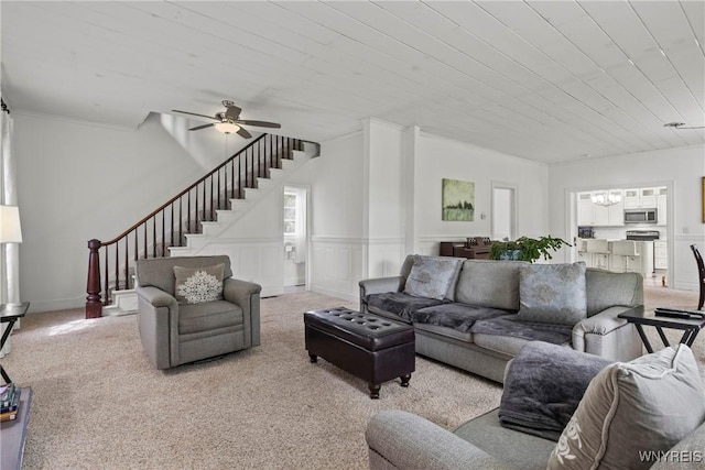 1822 Grover Rd, Aurora, NY 14052 - carpeted living room featuring stairs, ceiling fan, wooden ceiling, ornamental molding, and a chandelier