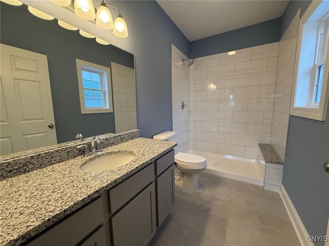 10 Platten Dr, Elbridge, NY 13080 - bathroom featuring vanity, toilet, tiled shower, and healthy amount of natural light