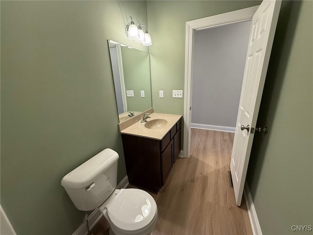10 Platten Dr, Elbridge, NY 13080 - half bathroom featuring wood finished floors, toilet, vanity, and baseboards