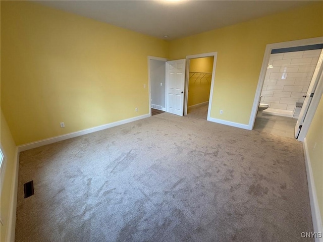 10 Platten Dr, Elbridge, NY 13080 - unfurnished bedroom with carpet floors, a walk in closet, baseboards, a closet, and connected bathroom