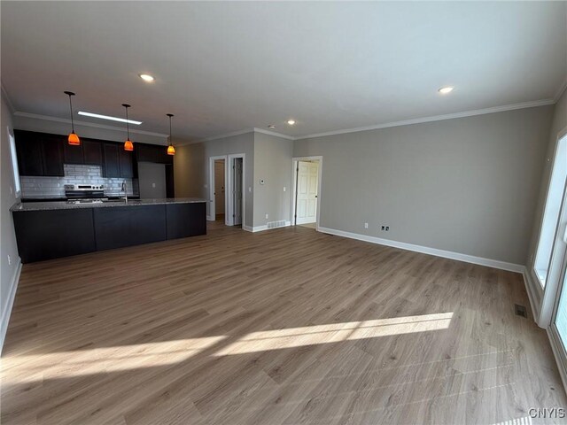 10 Platten Dr, Elbridge, NY 13080 - unfurnished living room with baseboards, recessed lighting, crown molding, a sink, and light wood-style floors