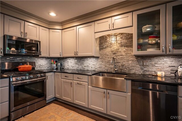 161 Portaferry Lake Dr, Pitcairn, NY 13648 - kitchen featuring appliances with stainless steel finishes, a sink, dark countertops, and ornamental molding