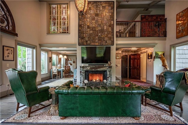 161 Portaferry Lake Dr, Pitcairn, NY 13648 - living room with a towering ceiling, healthy amount of natural light, wood finished floors, a fireplace, and beam ceiling