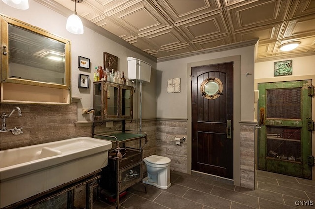 161 Portaferry Lake Dr, Pitcairn, NY 13648 - bathroom with wainscoting, tile walls, tile patterned floors, toilet, and vanity