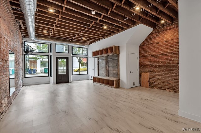 871 Seneca St, Buffalo, NY 14210 - unfurnished living room with brick wall and a towering ceiling