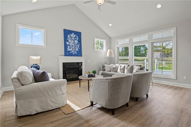 35 Chase Meadow Trl, Mendon, NY 14472 - living room with a glass covered fireplace, ceiling fan, baseboards, wood finished floors, and high vaulted ceiling