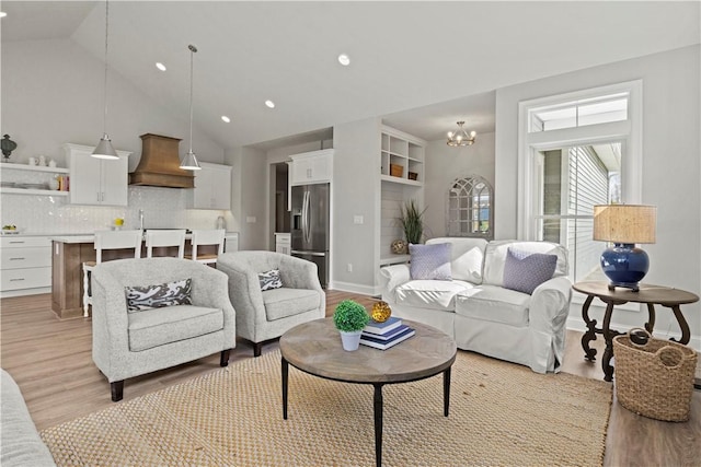 35 Chase Meadow Trl, Mendon, NY 14472 - living area with light wood-style floors, recessed lighting, a chandelier, baseboards, and high vaulted ceiling