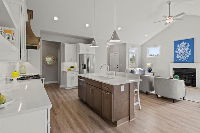 35 Chase Meadow Trl, Mendon, NY 14472 - kitchen with appliances with stainless steel finishes, a sink, open floor plan, light wood-style floors, and a kitchen breakfast bar