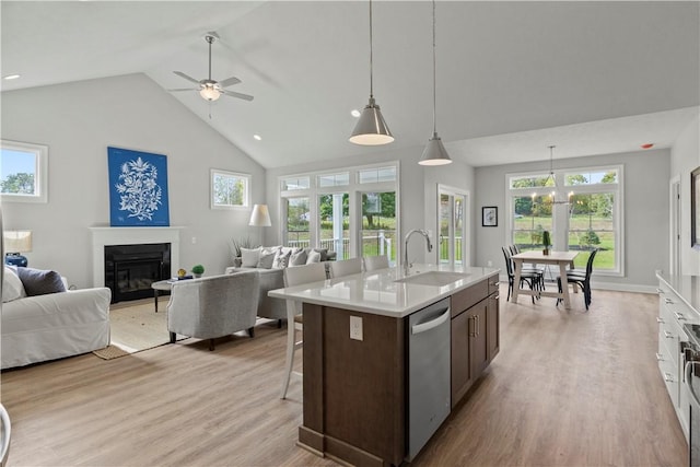 35 Chase Meadow Trl, Mendon, NY 14472 - kitchen featuring a sink, stainless steel dishwasher, open floor plan, ceiling fan, and high vaulted ceiling