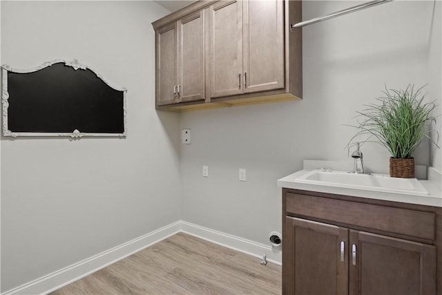 35 Chase Meadow Trl, Mendon, NY 14472 - laundry area featuring light wood-type flooring, baseboards, and cabinet space