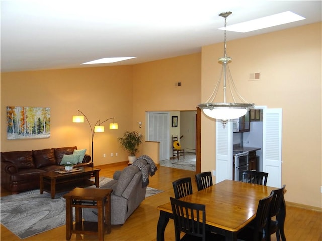 1737 Genesee Rd, Elmira, NY 14905 - dining room with light wood-style flooring, a towering ceiling, and baseboards