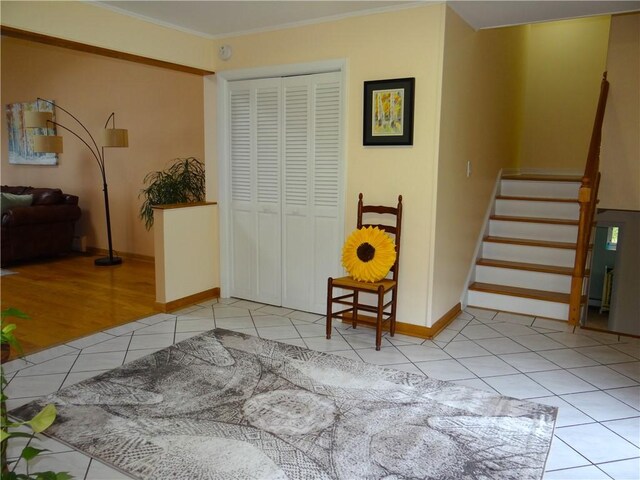 1737 Genesee Rd, Elmira, NY 14905 - sitting room featuring light tile patterned flooring, crown molding, baseboards, and stairs