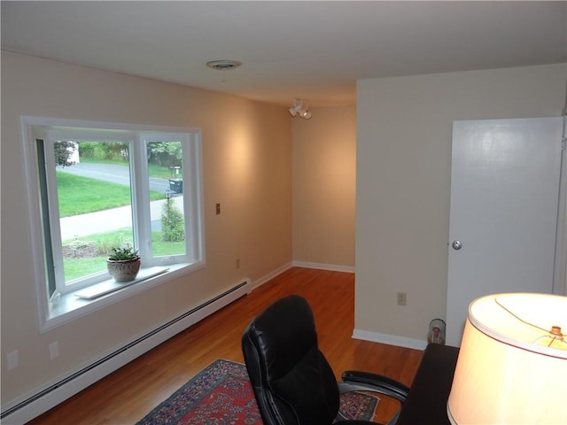 1737 Genesee Rd, Elmira, NY 14905 - office space featuring a baseboard heating unit, wood finished floors, and baseboards