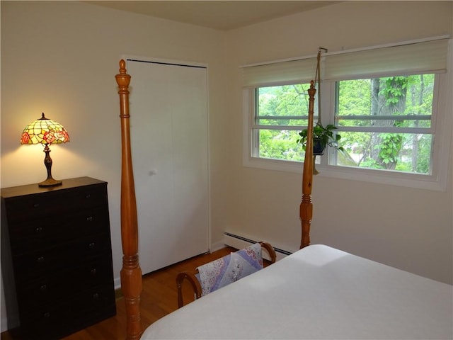 1737 Genesee Rd, Elmira, NY 14905 - bedroom featuring wood finished floors, baseboard heating, and a closet
