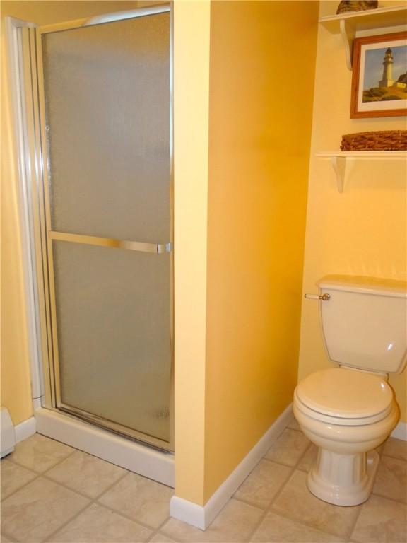 1737 Genesee Rd, Elmira, NY 14905 - bathroom with toilet, a stall shower, baseboards, and tile patterned flooring