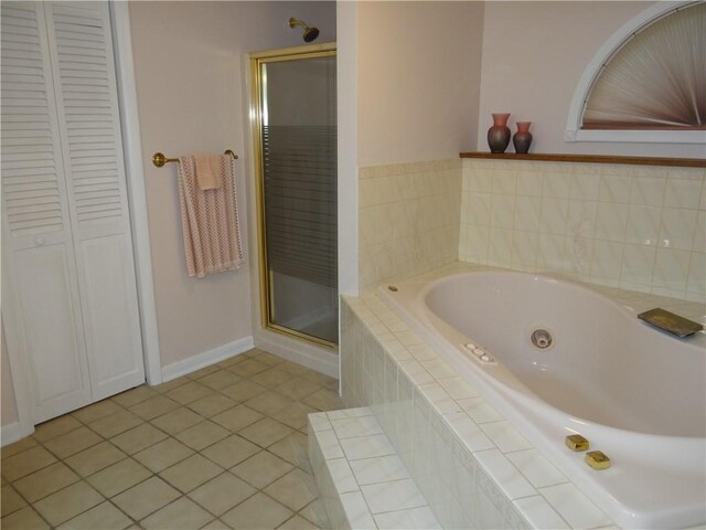 1737 Genesee Rd, Elmira, NY 14905 - bathroom with a closet, a jetted tub, tile patterned flooring, and a shower stall