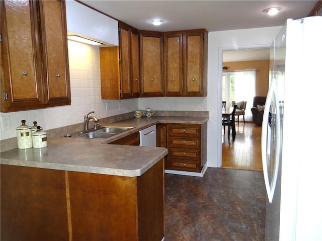 1737 Genesee Rd, Elmira, NY 14905 - kitchen with freestanding refrigerator, a sink, brown cabinets, and backsplash