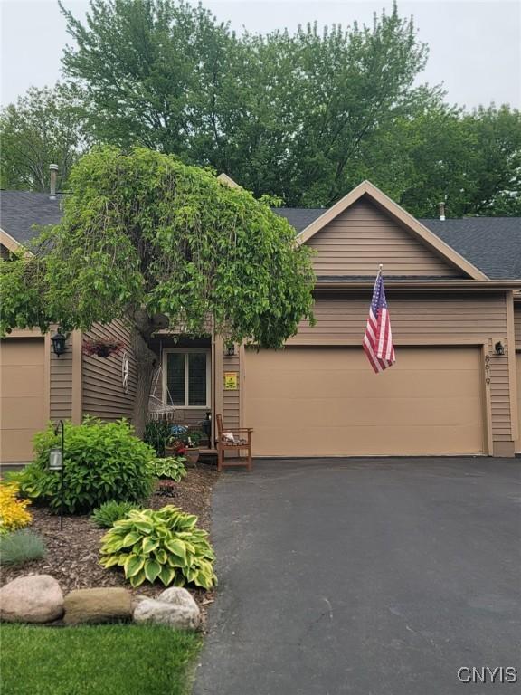 8619 Wrenwood Cir, Lysander, NY 13027 - view of front of property with a garage, driveway, and roof with shingles