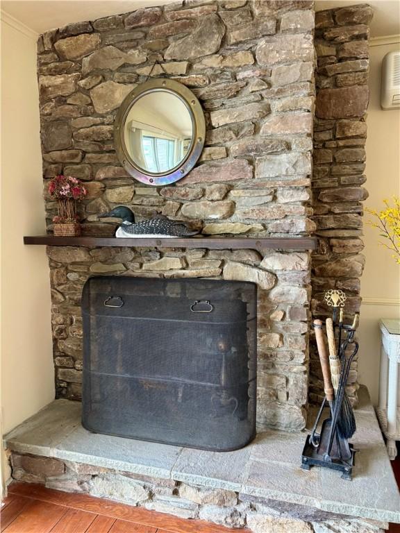 63 Lakeview Dr N, Middlefield, NY 13326 - detailed view of a fireplace, wood finished floors, and crown molding