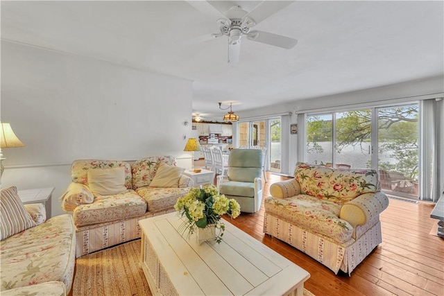 63 Lakeview Dr N, Middlefield, NY 13326 - living room with ceiling fan, wood-type flooring, and a water view