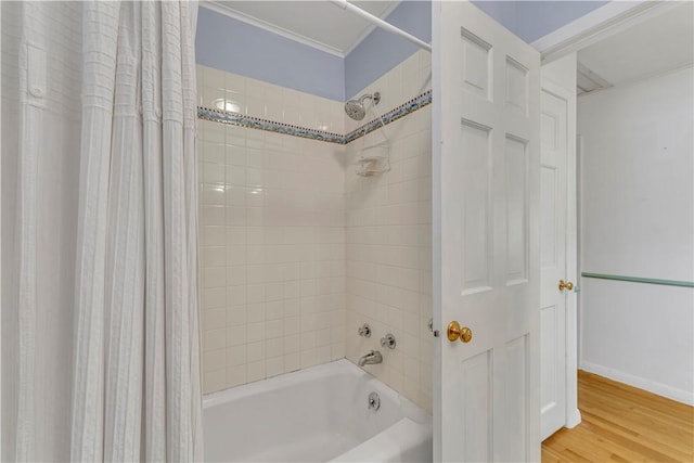 63 Lakeview Dr N, Middlefield, NY 13326 - bathroom featuring shower / bath combo with shower curtain, crown molding, wood finished floors, and baseboards