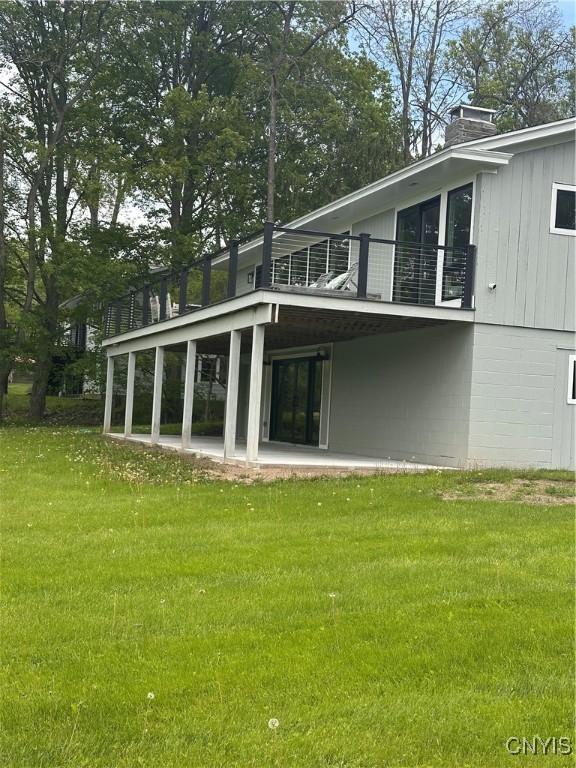 2089 Spring St, Hamilton, NY 13346 - rear view of property with a yard, a balcony, a chimney, and a patio area