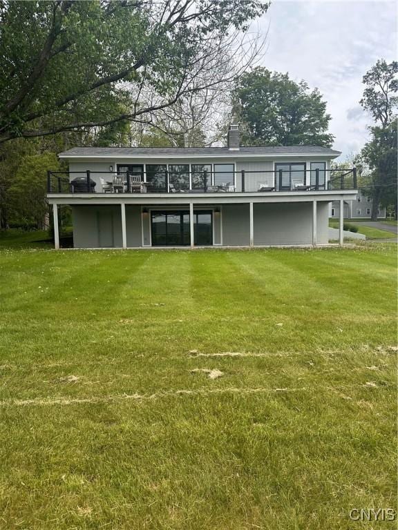 2089 Spring St, Hamilton, NY 13346 - view of front facade with a front yard, a wooden deck, and a chimney
