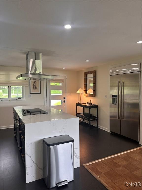 2089 Spring St, Hamilton, NY 13346 - kitchen with stainless steel built in fridge, island range hood, black electric stovetop, recessed lighting, and baseboards