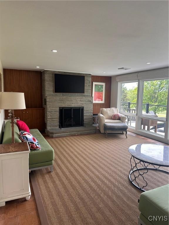 2089 Spring St, Hamilton, NY 13346 - living area featuring a large fireplace, recessed lighting, and wood walls