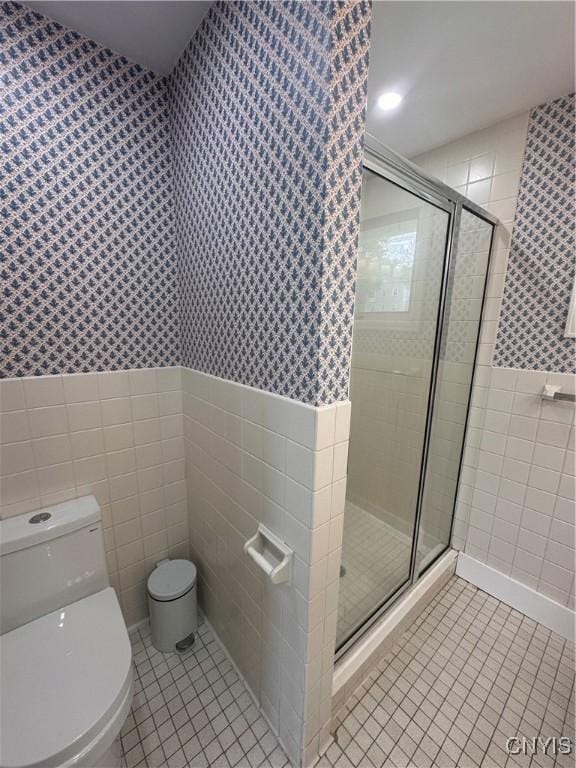 2089 Spring St, Hamilton, NY 13346 - full bathroom featuring tile walls, wallpapered walls, tile patterned floors, toilet, and wainscoting