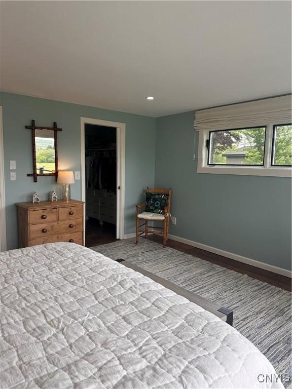 2089 Spring St, Hamilton, NY 13346 - bedroom with multiple windows, baseboards, recessed lighting, a walk in closet, and wood finished floors