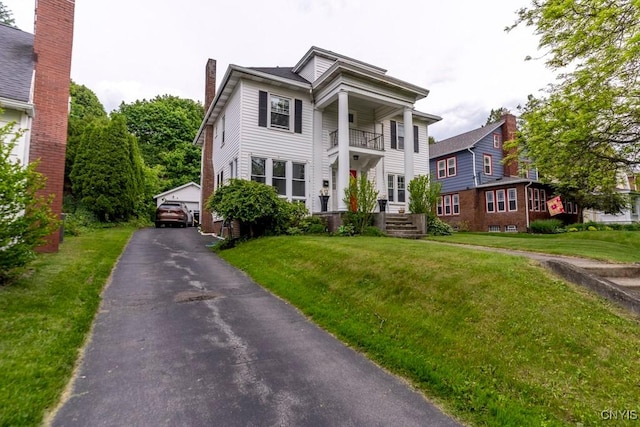 207 Twin Hills Dr, Syracuse, NY 13207 - greek revival inspired property featuring a front lawn, an outdoor structure, a detached garage, and a chimney