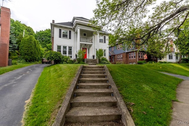 207 Twin Hills Dr, Syracuse, NY 13207 - greek revival house featuring a balcony, a front yard, and a chimney