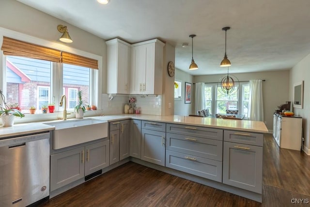 207 Twin Hills Dr, Syracuse, NY 13207 - kitchen featuring stainless steel dishwasher, gray cabinetry, a sink, a peninsula, and light countertops
