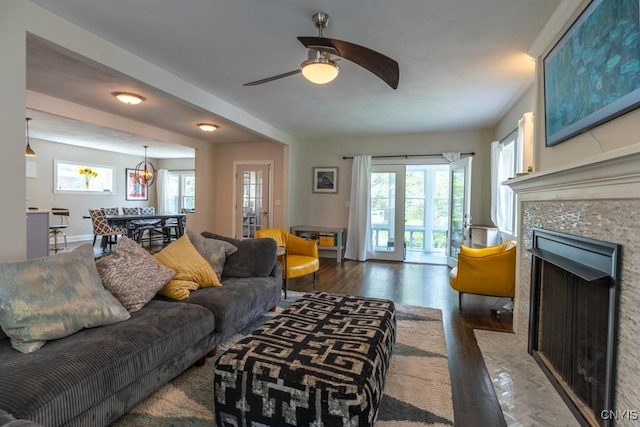 207 Twin Hills Dr, Syracuse, NY 13207 - living room featuring healthy amount of natural light, a tile fireplace, wood finished floors, and a ceiling fan