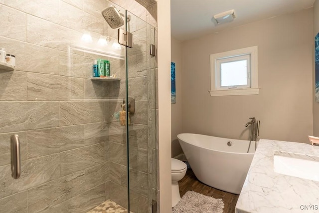 207 Twin Hills Dr, Syracuse, NY 13207 - bathroom with a shower stall, wood finished floors, a freestanding bath, vanity, and toilet